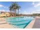 Community pool with crystal-clear water, palm trees, lounge chairs and inviting recreational space at 3439 E Shannon St, Gilbert, AZ 85295