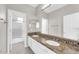 Bathroom features a double sink vanity, tile backsplash, and a shower with glass door at 3925 E Vallejo Dr, Gilbert, AZ 85298