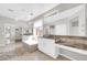 Bright bathroom featuring dual vanities, a soaking tub, and a separate shower area at 3925 E Vallejo Dr, Gilbert, AZ 85298