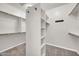 Spacious walk-in closet with built-in shelving and multiple hanging rods at 3925 E Vallejo Dr, Gilbert, AZ 85298