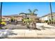 Beautiful two-story home featuring a well-manicured yard with mature palm trees and a circular driveway at 3925 E Vallejo Dr, Gilbert, AZ 85298