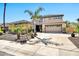Gorgeous home with palm trees, desert landscaping, and long driveway leading to a three-car garage at 3925 E Vallejo Dr, Gilbert, AZ 85298