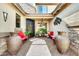 Charming front entrance with unique iron door, red benches, and desert decor at 3925 E Vallejo Dr, Gilbert, AZ 85298