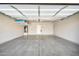 Spacious garage with epoxy floor, shelving, water heater, and fire extinguisher at 3925 E Vallejo Dr, Gilbert, AZ 85298