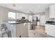 Contemporary kitchen boasting granite countertops, white cabinetry, and a breakfast bar with seating at 3925 E Vallejo Dr, Gilbert, AZ 85298