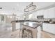 Bright kitchen with stainless steel appliances, white cabinets and large island at 3925 E Vallejo Dr, Gilbert, AZ 85298