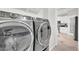 Modern laundry room featuring front load washer and dryer, adjacent to kitchen at 3925 E Vallejo Dr, Gilbert, AZ 85298