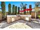 Outdoor kitchen complete with built-in grill, stainless steel refrigerator and stone counter at 3925 E Vallejo Dr, Gilbert, AZ 85298