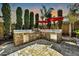 Custom stone outdoor kitchen featuring built-in grill, fridge, and ample counter space for entertaining at 3925 E Vallejo Dr, Gilbert, AZ 85298