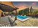 Stunning backyard pool area with a covered patio, a built-in barbeque, and mature landscaping at 3925 E Vallejo Dr, Gilbert, AZ 85298