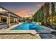 Beautiful backyard pool with water features, lush landscaping, and outdoor dining space at 3925 E Vallejo Dr, Gilbert, AZ 85298