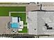 An aerial view of the backyard featuring a sparkling pool, outdoor seating, pristine turf, and modern design at 4023 E Minton Cir, Mesa, AZ 85215