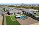 Aerial view of a large property with mountain views, a pool, manicured lawn and desert landscaping at 4023 E Minton Cir, Mesa, AZ 85215