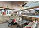 Inviting covered outdoor patio area, perfect for entertaining with a built-in seating and a backyard pool at 4023 E Minton Cir, Mesa, AZ 85215