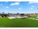 Beautiful backyard featuring artificial grass, a swimming pool, spa and covered outdoor seating area at 4023 E Minton Cir, Mesa, AZ 85215