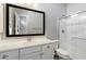 Well-lit bathroom with white cabinets, a shower, and a large framed mirror at 4023 E Minton Cir, Mesa, AZ 85215