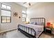 Comfortable bedroom featuring tall ceilings, wood-look floors, and decorative window accents at 4023 E Minton Cir, Mesa, AZ 85215