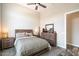 Neutral bedroom featuring a decorative lamp, wood-look floors, and a coordinating dresser at 4023 E Minton Cir, Mesa, AZ 85215