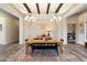 Inviting dining area with decorative lighting, exposed beams, and a large table set for gathering at 4023 E Minton Cir, Mesa, AZ 85215