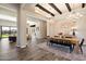 Open-concept dining room with wood floors, exposed beams, chandelier, and view to living spaces at 4023 E Minton Cir, Mesa, AZ 85215