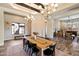 Elegant dining room features a large table, chandelier lighting, and an inviting atmosphere at 4023 E Minton Cir, Mesa, AZ 85215