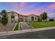 Stunning single-story home with lush lawn, mature trees, and a charming stone-accented entrance at 4023 E Minton Cir, Mesa, AZ 85215