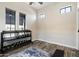 Bright home gym with wood floors, dumbbell rack, and two sunny windows at 4023 E Minton Cir, Mesa, AZ 85215