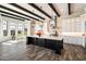 Bright kitchen features a large island with quartz countertops, stainless steel appliances, and designer lighting at 4023 E Minton Cir, Mesa, AZ 85215
