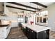 Modern kitchen with a large island, stainless steel appliances, and a view to the living room at 4023 E Minton Cir, Mesa, AZ 85215