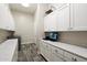 Bright laundry room with white cabinets, countertops, sink and modern washer and dryer at 4023 E Minton Cir, Mesa, AZ 85215