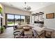 Bright living room with large windows, comfortable sectional, and views of the outdoor pool at 4023 E Minton Cir, Mesa, AZ 85215