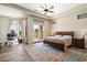 Bright and spacious main bedroom with wood floors, ceiling fan, and natural light at 4023 E Minton Cir, Mesa, AZ 85215