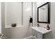 Cozy powder room features modern fixtures, neutral paint, and a pedestal sink at 4023 E Minton Cir, Mesa, AZ 85215