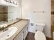 Bathroom with granite countertop, a large mirror and tile details at 4111 W Desert Cove Ave, Phoenix, AZ 85029