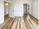 A bedroom featuring wood floors, white walls, and open door to another room at 4111 W Desert Cove Ave, Phoenix, AZ 85029