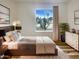 Comfortable bedroom with a queen bed, modern decor, and views of desert landscaping at 4111 W Desert Cove Ave, Phoenix, AZ 85029