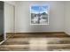 Bedroom boasts wood floors, neutral paint, and large window letting in natural light at 4111 W Desert Cove Ave, Phoenix, AZ 85029
