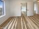 Bright bedroom features wood floors, white walls, and a sliding door closet at 4111 W Desert Cove Ave, Phoenix, AZ 85029