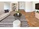 Bright living room features tile floors, a modern white sofa and stylish decor at 4111 W Desert Cove Ave, Phoenix, AZ 85029