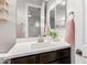 Bright bathroom with white countertop vanity, modern fixtures, and a decorative mirror at 4237 E Sierra Madre Ave, Gilbert, AZ 85296