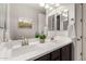 Modern bathroom featuring dual sinks, sleek fixtures, and a bright vanity mirror at 4237 E Sierra Madre Ave, Gilbert, AZ 85296