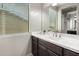 Bright bathroom featuring a large sink, wood cabinetry and a window offering plenty of natural light at 4237 E Sierra Madre Ave, Gilbert, AZ 85296
