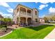 Attractive two-story home with a balcony, stone accents, a manicured lawn and attached garage at 4237 E Sierra Madre Ave, Gilbert, AZ 85296