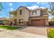 Beautiful two-story home featuring a balcony, stone accents, manicured landscaping, and a two-car garage at 4237 E Sierra Madre Ave, Gilbert, AZ 85296