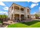 Attractive two-story home with a balcony, stone accents, a manicured lawn and attached garage at 4237 E Sierra Madre Ave, Gilbert, AZ 85296