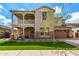 Charming two-story home featuring a balcony, stone accents, a well-manicured lawn and an attached garage at 4237 E Sierra Madre Ave, Gilbert, AZ 85296