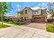 Attractive two-story home with a balcony, stone accents, manicured landscaping, and a two-car garage at 4237 E Sierra Madre Ave, Gilbert, AZ 85296