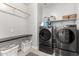Modern laundry room with front-load washer and dryer and a folding table at 4237 E Sierra Madre Ave, Gilbert, AZ 85296