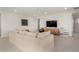 Bright living room with large sectional sofa, media cabinet, and contemporary decor at 4237 E Sierra Madre Ave, Gilbert, AZ 85296