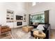 Bright living room featuring built-in shelves, fireplace, and sliding glass doors to backyard at 4237 E Sierra Madre Ave, Gilbert, AZ 85296